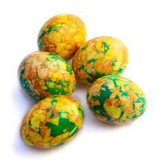 handmade yellow green easter eggs painted marbled over white background