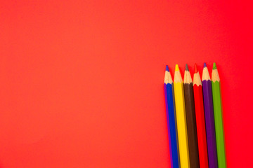Coloring pencils on colorful background. School stationery and office supplies. Colored pencils abstract background. Lots of pencils of different colors. Creative flat lay.