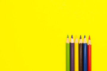 Coloring pencils on colorful background. School stationery and office supplies. Colored pencils abstract background. Lots of pencils of different colors. Creative flat lay.