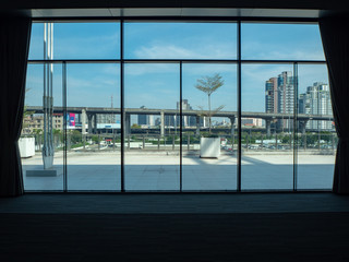 City view with cloudy blue sky from large window in convention building