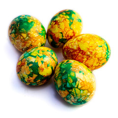 handmade yellow green easter eggs painted marbled over white background
