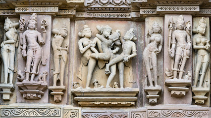 ancient stone sculptures carved into the wall of the temple