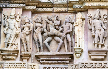 ancient stone sculptures carved into the wall of the temple