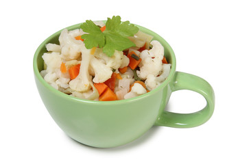 Porcelain plate with vegetable soup on white background