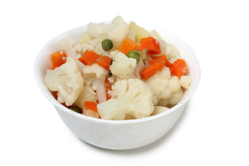 Porcelain plate with vegetable soup on white background