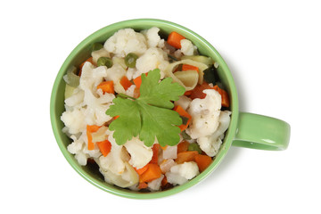 Porcelain plate with vegetable soup on white background