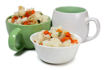Porcelain plate with vegetable soup on white background