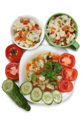 Porcelain plate with vegetable soup on white background