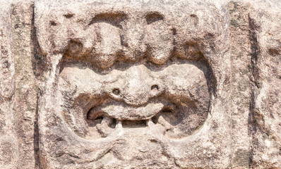 ancient stone sculptures carved into the wall of the temple