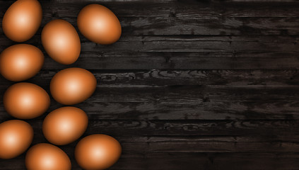 Close up of brown easter eggs on wooden background. Rustic dark background. Brown  Easter eggs on a wooden table. Invitation template design, greeting card, place for text