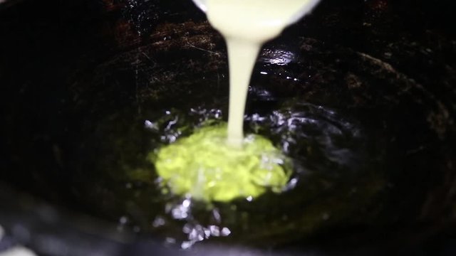 Frying local cake in oil and it is named pitha for Asian countries likes Bangladesh, India, Nepal etc.Preparing a local dessert. And this video is without sound.