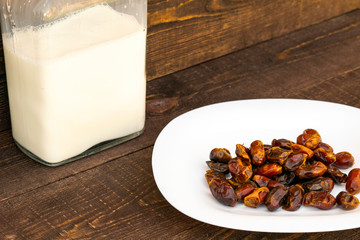 Hushaf - date milk, a traditional dish to Ramadan, cooking, ingredients, dates in a plate and milk in bottles are on the table