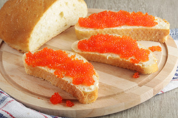 Sandwiches with butter and red caviar