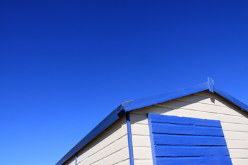 Colorful English beach huts against a blue sky