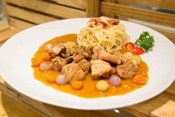  delicious beef stew with spaghetti on plate
