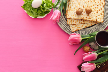 Pesah celebration concept (jewish Passover holiday). Traditional book with text in hebrew: Passover...