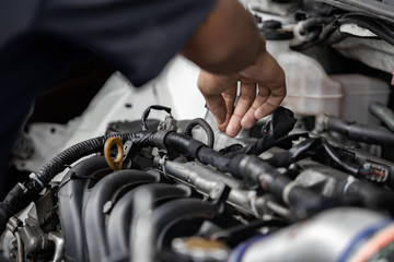 Fototapeta na wymiar Hands of auto mechanic repairing car engine in garage. Maintenance car.