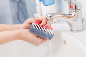 Woman washing her hands in sink