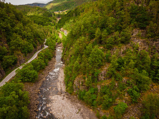 Fototapeta na wymiar Road and river in green mountains, Ryfylke Norway