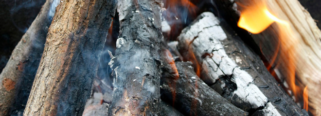 Fire. Closeup of pile of wood burning with flames in the fireplace.