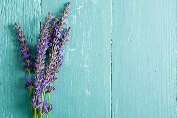 pink and purple lavender flowers on blue wood table background