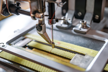 Fototapeta na wymiar Professional sewing machine close-up. Modern textile industry.