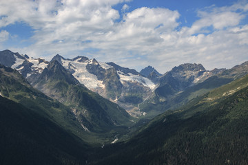 Panorama of mountains scene with dramatic blue sky in national park of Dombay