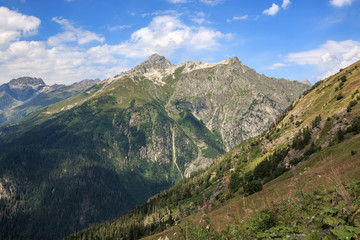 Naklejka premium Panorama of mountains scene with dramatic blue sky in national park of Dombay