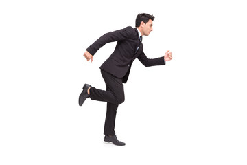 Handsome Caucasian businessman in formal suit is running isolated over white background