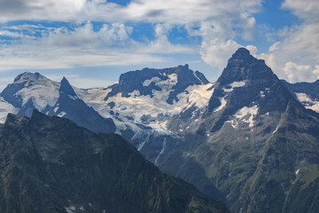 Panorama of mountains scene with dramatic blue sky in national park of Dombay