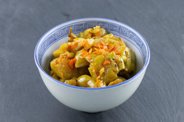 olive pickled in bowl on stone table.