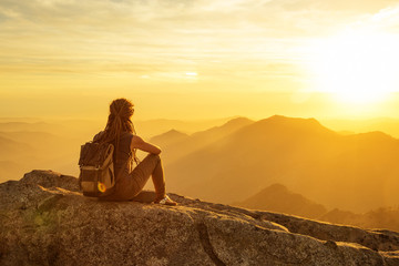 Hiker meets the sunset on the Moro rock in Sequoia national park, California, USA.