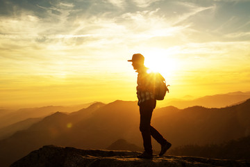 Hiker meets the sunset on the Moro rock in Sequoia national park, California, USA.