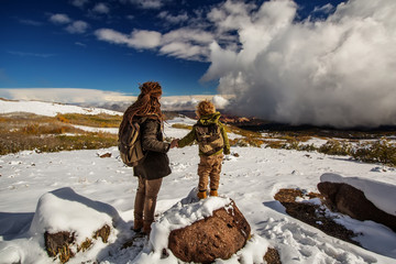 Obraz premium Mother with her little boy in snowy mountains