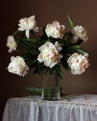 bouquet of white peonies in a glass jug.