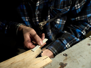 In the guitar workshop, Guitars Luthiers cuts off part of the saddle.
