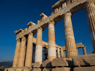 Columns of Parthenon temple on Acropolis, Athens, Greece at sunset against blue sky
