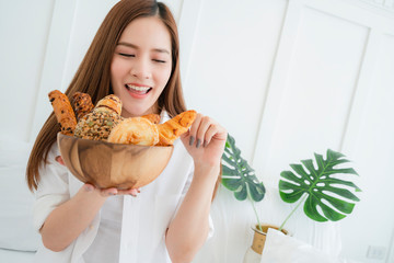 healthy ideas concept portrait of beautiful attractive asian woman hand hold bowl of bread with happiness and joyful