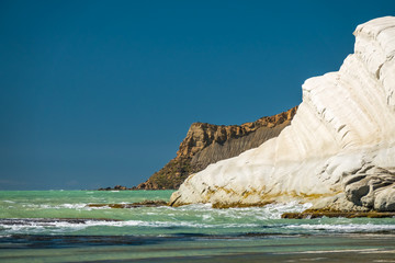 Fototapeta na wymiar The Scala dei Turchi (Stair of the Turks), a spectacular white rocky cliff on the coast of Sicily, Italy. The rock formation in the shape of a staircase lies between two sandy beaches.