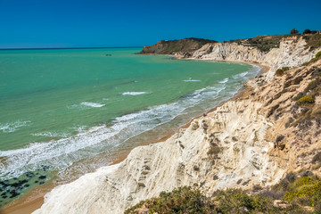 Obraz premium The Scala dei Turchi (Stair of the Turks), a spectacular white rocky cliff on the coast of Sicily, Italy. The rock formation in the shape of a staircase lies between two sandy beaches.
