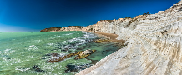 Fototapeta premium The Scala dei Turchi (Stair of the Turks), a spectacular white rocky cliff on the coast of Sicily, Italy. The rock formation in the shape of a staircase lies between two sandy beaches.