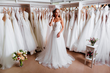 Female trying on wedding dress in a shop