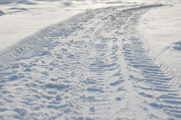 car tire tracks on the snow closeup