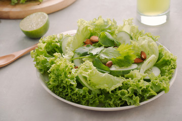 Mix of green fruits and vegetables on rustic wooden background