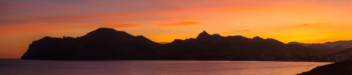 Rocks of the extinct volcano Karadag in the Crimea at sunset. Panorama
