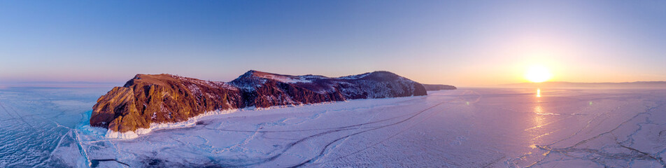 Khoboy (Cape Khoboy) in winter sunset. Russia, Lake Baikal, Olkhon Island. The northernmost point of the island of Olkhon. Aerial Photography Panorama - obrazy, fototapety, plakaty