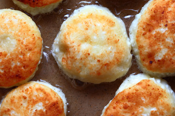 Fragrant ruddy golden with a brown crust freshly cooked syrup curds(cheesecake) with strawberry jam and sour cream piping hot.