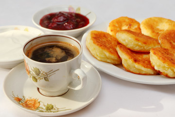 Fragrant ruddy golden with a brown crust freshly cooked syrup curds(cheesecake) with strawberry jam and sour cream piping hot.