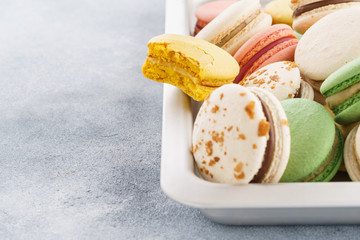 Homemade colorful macarons on a baking tray.