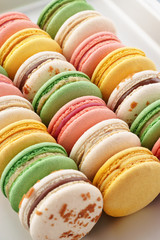 Colorful french macarons on a baking tray.